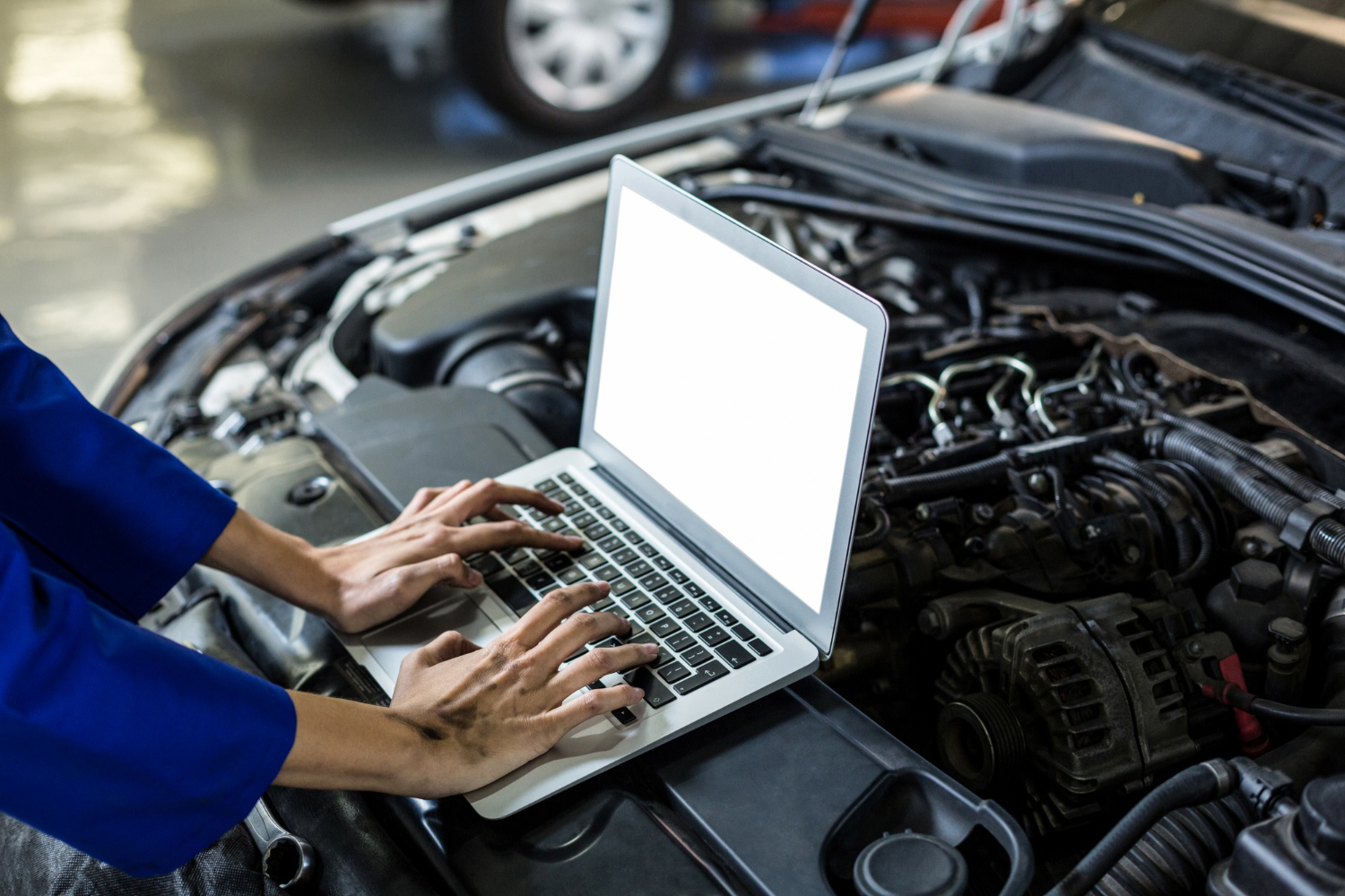 hands female mechanic using laptop